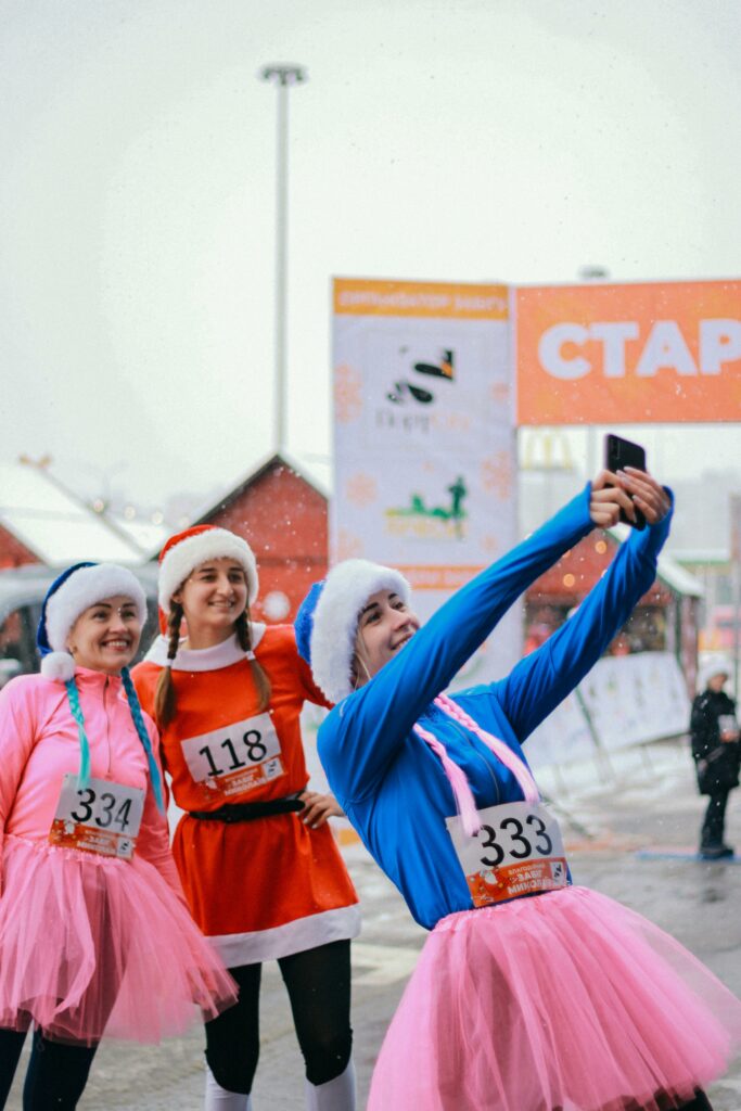 pexels-photo-10587573-10587573 Group of women in festive costumes taking a selfie during a winter running event.